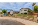Beautiful exterior with solar panels, mature trees, a well-kept lawn, and a charming fence, perfect for Gathering enjoyment at 14001 N 34Th Dr, Phoenix, AZ 85053