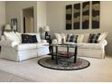 Inviting living room with plush seating, stylish decor, and ample natural light at 15753 W Kino Dr, Surprise, AZ 85374