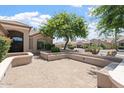 An inviting patio provides a cozy outdoor space perfect for relaxation, framed by mature landscaping, and desert charm at 15989 W Indianola Ave, Goodyear, AZ 85395