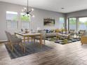 Bright living room featuring modern decor, wood-look tile flooring, and abundant natural light at 16006 W Electra Ln, Surprise, AZ 85387