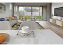 Comfortable living area with sliding glass doors to the backyard and a view of outdoor seating at 16006 W Electra Ln, Surprise, AZ 85387