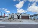 Charming single-story home with a well-kept lawn, two-car garage, and stylish curb appeal at 19152 N Bandin Dr, Maricopa, AZ 85138