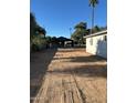 Large dirt backyard showing garage-like structure; xeriscaping for easy maintenance at 2148 W Hayward Ave, Phoenix, AZ 85021