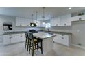 Modern kitchen featuring white cabinets, granite counters, stainless appliances, and a central island at 2148 W Hayward Ave, Phoenix, AZ 85021
