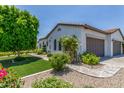 Beautiful home exterior featuring a well-manicured lawn, mature trees, and a detached garage with ample parking at 24372 N 96Th Ln, Peoria, AZ 85383
