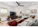 Bright living room boasts a modern ceiling fan, large windows, cozy furniture and contemporary decor at 3053 W Straight Arrow Ln, Phoenix, AZ 85083