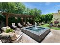 Relaxing backyard retreat with a water feature and lounge chairs under a pergola at 3511 N 39Th Pl, Phoenix, AZ 85018