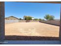 View of a spacious backyard with dirt and block wall, ready for a new owner's personal touch at 37172 W Parador Ln, Maricopa, AZ 85138