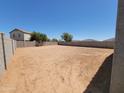 Spacious backyard with dirt and block wall, perfect for creating your dream outdoor oasis at 37172 W Parador Ln, Maricopa, AZ 85138