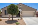Charming single-story home featuring desert landscaping, a two-car garage, and a welcoming front porch at 41005 W Crane Dr, Maricopa, AZ 85138