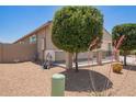 Side yard featuring a fenced area with desert landscaping at 41005 W Crane Dr, Maricopa, AZ 85138
