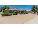 Beautiful brick home featuring a well-manicured gravel yard and lush landscaping at 4402 W El Caminito Dr, Glendale, AZ 85302