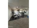 Open kitchen and dining area featuring white cabinetry, an island with seating, and hardwood floors at 4823 W Palm Ln, Phoenix, AZ 85035