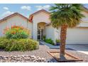 Inviting front entrance featuring desert landscaping, orange flowers, and a security screen door at 6301 S Tournament Ln, Chandler, AZ 85249