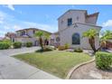 Attractive home with green lawn, palm trees, and a convenient three-car garage at 6840 S Crystal Way, Chandler, AZ 85249