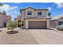 Charming two-story home with a well-maintained yard and attached two car garage, under a bright blue sky at 706 N El Dorado Dr, Gilbert, AZ 85233