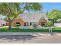 Charming brick home featuring a manicured lawn and eye-catching architectural details at 733 W El Camino Dr, Phoenix, AZ 85021