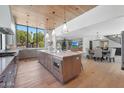 Open-concept kitchen and dining area with a large island and modern appliances at 733 W El Camino Dr, Phoenix, AZ 85021