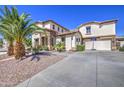 Beautiful home with a three car garage and stone accents, complemented by desert landscaping at 7419 S 25Th Dr, Phoenix, AZ 85041