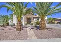 Inviting home exterior with stone accents, palm trees, and a charming walkway to the front door at 7419 S 25Th Dr, Phoenix, AZ 85041