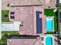 Aerial view of a home with solar panels, swimming pool, a putting green, and outdoor seating area at 761 W Desert Hollow Dr, San Tan Valley, AZ 85143