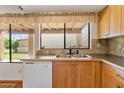 Kitchen view highlighting the sink, cabinetry, and ample natural light from the window at 7707 E Park View Dr, Mesa, AZ 85208