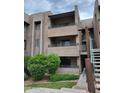 Exterior view of a three-story condo building with well-maintained landscaping, showing the building's charming facade at 7777 E Main St # 227, Scottsdale, AZ 85251