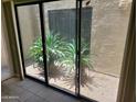 Private courtyard visible through sliding glass doors with desert landscaping at 7914 E Bonita Dr, Scottsdale, AZ 85250