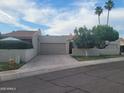 Charming single-story home featuring a two-car garage, desert landscaping, and a tile roof at 7914 E Bonita Dr, Scottsdale, AZ 85250