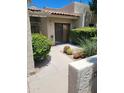 Inviting front entrance with desert landscaping, lush bushes, and a private courtyard at 7914 E Bonita Dr, Scottsdale, AZ 85250