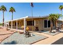 Inviting covered porch, xeriscaped yard and sidewalk lead to the front door at 8103 E Southern Ave # 119, Mesa, AZ 85209