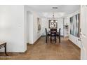 Elegant dining room with stylish lighting and travertine tile floors at 8787 E Mountain View Rd # 1100, Scottsdale, AZ 85258