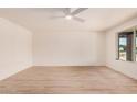 Spacious bedroom with modern wood floors and a large window at 9414 N 50Th Dr, Glendale, AZ 85302