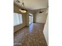 Bright living room boasts tile floors, high ceilings, ceiling fan and sliding glass door to the backyard at 1015 S Val Vista Dr # 52, Mesa, AZ 85204