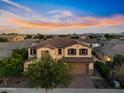 Stunning two-story home featuring a well-manicured lawn and brick-paved driveway at 10331 E Starion Ave, Mesa, AZ 85212