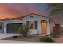 Charming single-story home featuring desert landscaping and a cozy front porch with stone pathway at 11658 E Chevelon Trl, Gold Canyon, AZ 85118