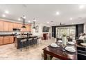 Open-concept kitchen featuring granite countertops, stainless steel appliances, and an island with seating at 11658 E Chevelon Trl, Gold Canyon, AZ 85118