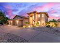 Beautifully landscaped home exterior with a circular driveway and inviting architectural design at 12015 S Tuzigoot Dr, Phoenix, AZ 85044