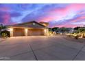 Exterior image capturing the home's spacious driveway, elegant landscaping, and architectural details at 12015 S Tuzigoot Dr, Phoenix, AZ 85044