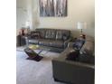 Comfortable living room showcasing plush couches, glass coffee table, and modern decor at 14145 N 92Nd St # 2011, Scottsdale, AZ 85260