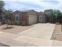 Inviting single-Gathering home with a two-car garage, attractive landscaping, and a welcoming entrance at 14841 W Desert Hills Dr, Surprise, AZ 85379