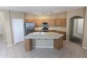Open kitchen with a large island, stainless steel appliances, and ample counter space at 14841 W Desert Hills Dr, Surprise, AZ 85379