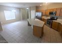 Well-lit kitchen featuring a central island, stainless steel appliances, and generous counter space at 14841 W Desert Hills Dr, Surprise, AZ 85379