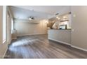 Open-concept living room showcasing a modern kitchen, sleek bar, and a staircase to the upper level at 16 W Encanto Blvd # 110, Phoenix, AZ 85003
