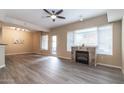 Bright living room with modern ceiling fan, fireplace, and door to the outside at 16 W Encanto Blvd # 110, Phoenix, AZ 85003