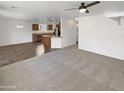 Bright, open-concept living area, seamlessly blends into the dining space and kitchen, perfect for entertaining at 18148 W Lundberg St, Surprise, AZ 85388
