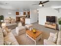 Bright, open-concept living room showcases modern furnishings and an adjacent kitchen and dining area at 18148 W Lundberg St, Surprise, AZ 85388