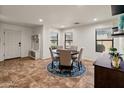 Elegant dining room with a round table, upholstered chairs, and stylish decor, perfect for Gathering meals and gatherings at 18542 W Valerie Dr, Surprise, AZ 85374