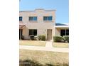 Charming two-story home with a well-maintained lawn and inviting front entrance at 225 N Standage -- # 45, Mesa, AZ 85201