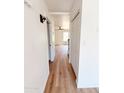 Hallway with light wood flooring, light fixtures and white closet doors at 225 N Standage -- # 45, Mesa, AZ 85201